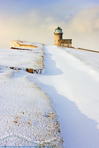slides/Late Winter light.jpg winter sussex east snow coast beachy head lighthouse eastbourne rocks water ocean people person clouds storm cliffs pebbles red white blue Late Winter light